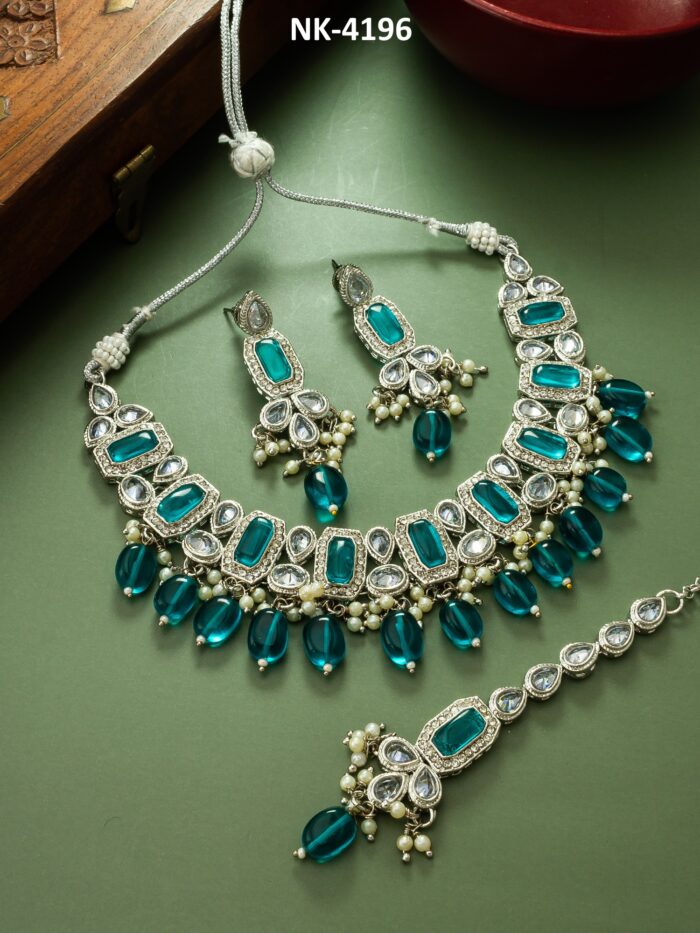 Stunning kundan jewelry set with blue accents, reminiscent of the ocean's glow.
