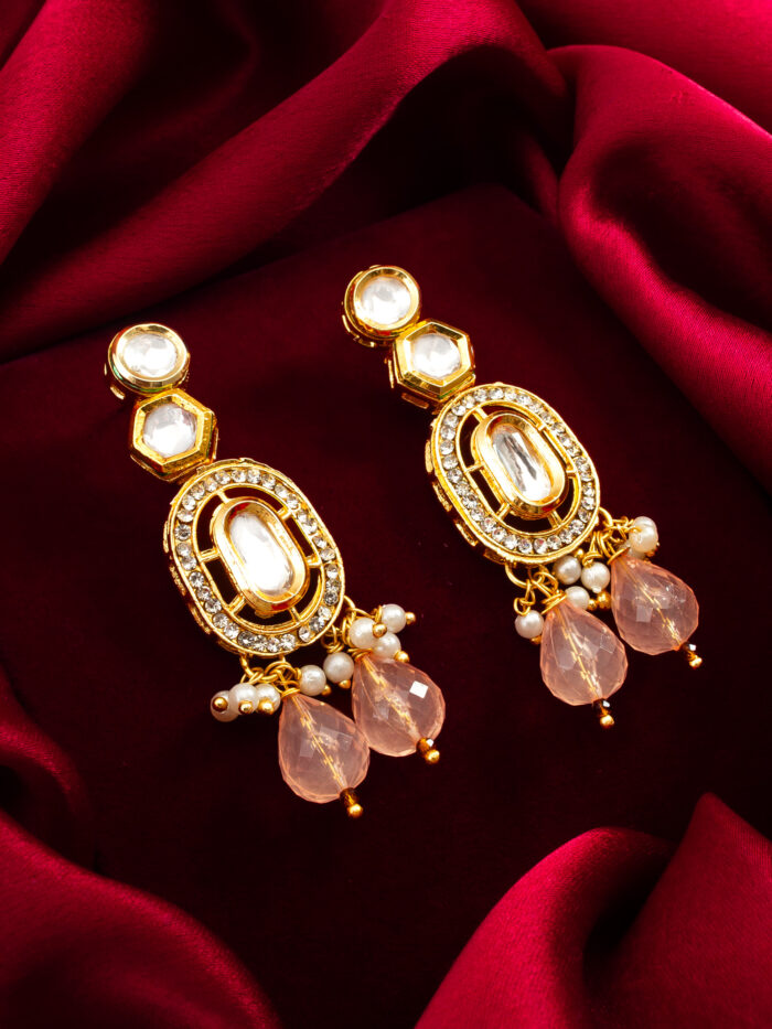 Designer earrings with a soft blush color, gold plating, and a radiant shine.