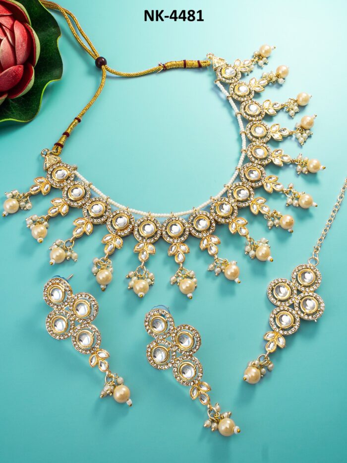 Elegant jewelry set with pearl accents and a subtle glow, featuring meenakari enamel work.