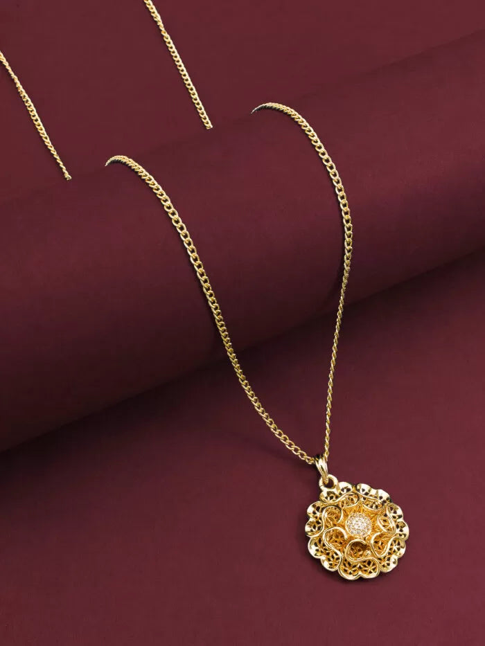 Elegant gold pendant featuring a blooming floral design with a pearl center.
