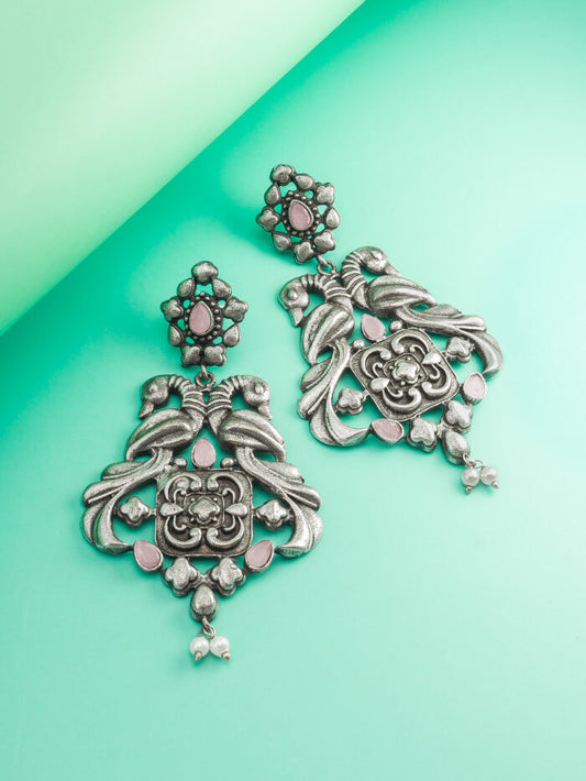 Vintage-style drop earrings with a floral blossom design and delicate pink accents.