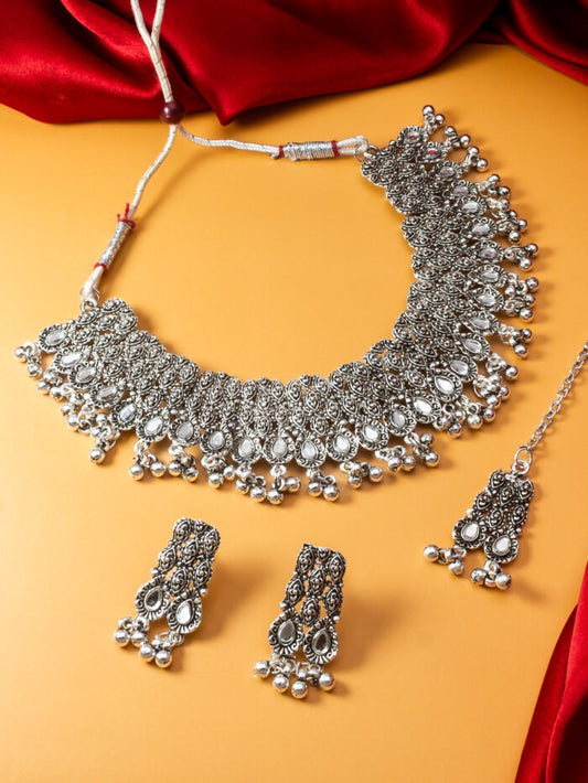 Vintage-style oxidized silver necklace set with earrings and a mang tikka.