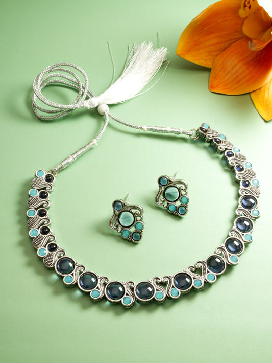 Oxidized silver necklace and earrings set featuring blue kundan work.