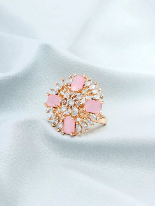 Elegant cocktail ring with a soft blush color and a blooming floral design featuring 'AD' (American Diamonds).