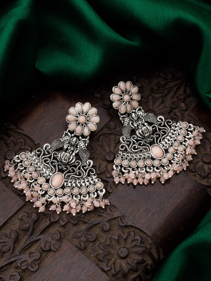 Oxidised silver temple-style earrings with a soft blush color and a blooming floral design.