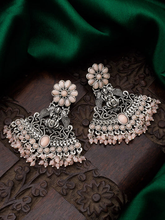Oxidised silver temple-style earrings with a soft blush color and a blooming floral design.