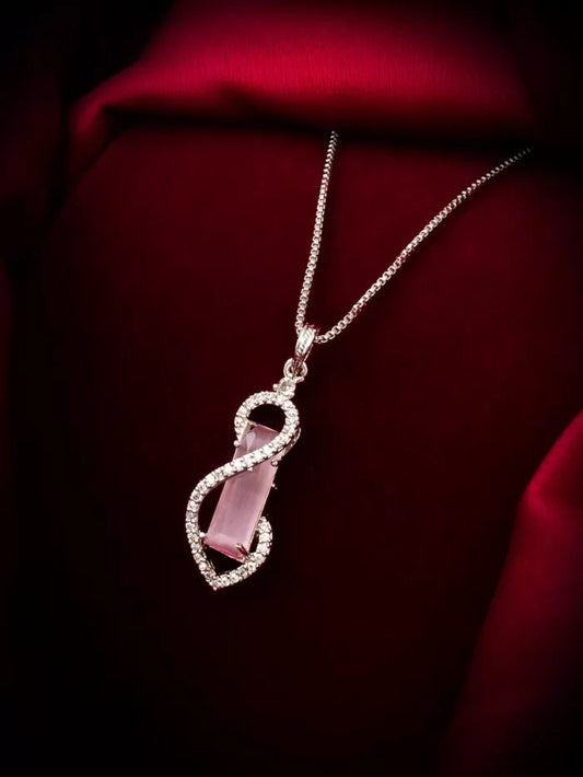 Elegant pendant with a soft blush color and a subtle twirling design element.