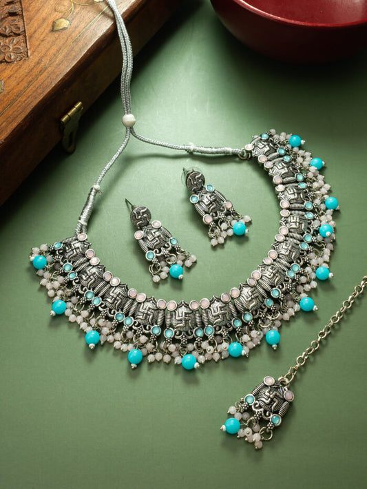 Bohemian tribal-style necklace set in oxidized silver with blue and white bead accents.