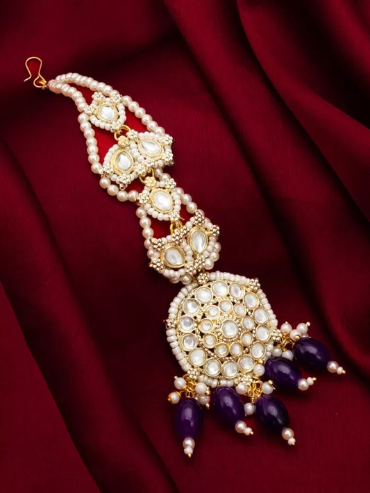 Elegant maang tikka with kundan work and a celestial-inspired design with a subtle glow.