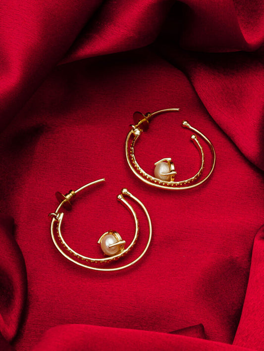 Designer hoop earrings with a celestial 'orbit' design featuring gold and pearls.