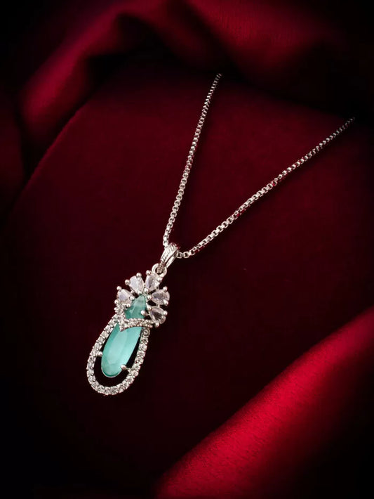 Beautiful pendant featuring a blooming floral design with an emerald-colored stone.