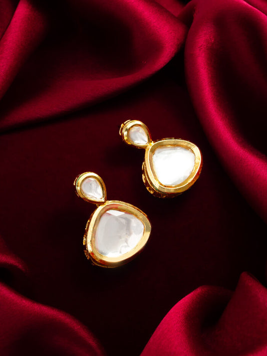 Designer earrings with white kundan work and an ethereal, glowing appearance.