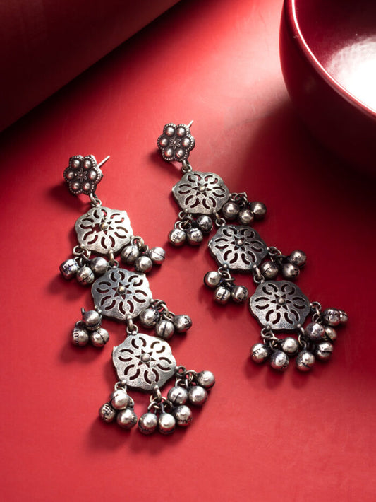 Oxidised silver dangler earrings with a carved floral design and beaded tassels.