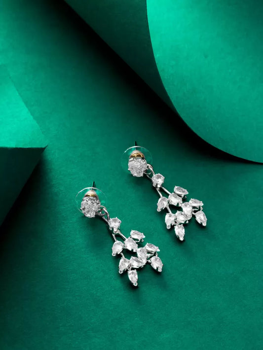 Dangling earrings with a floral design and 'AD' (American Diamond) stones.