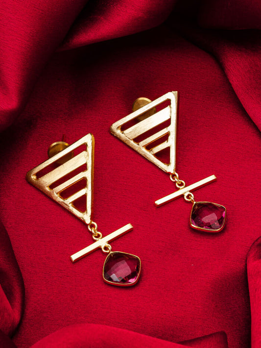 Designer statement earrings with a geometric purple design, inspiring a 'muse'.