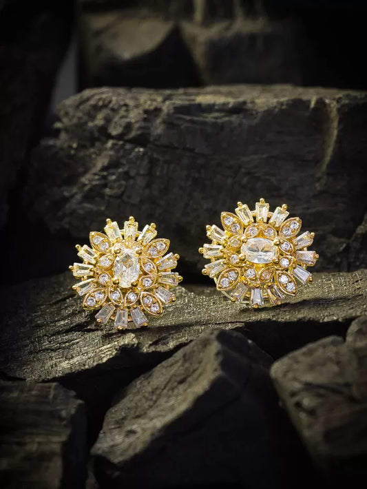 Shining gold stud earrings with a radiant floral design.