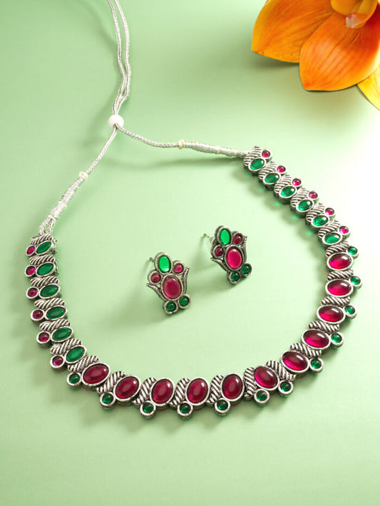 Oxidized silver necklace and earrings set featuring green and pink kundan work.