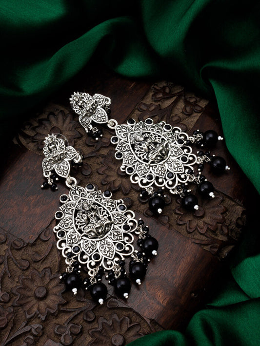 Oxidised silver earrings with a lotus flower design, reminiscent of midnight.
