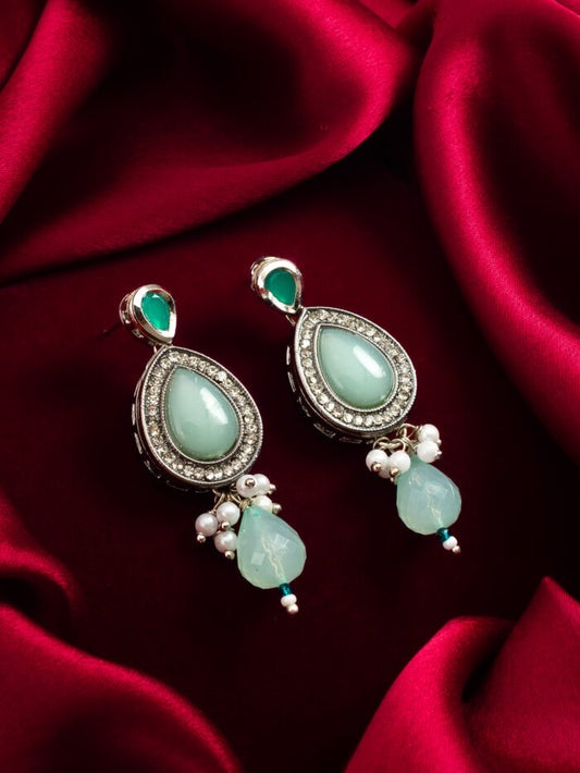 Designer earrings with a refreshing mint color, silver plating, and a subtle glow.