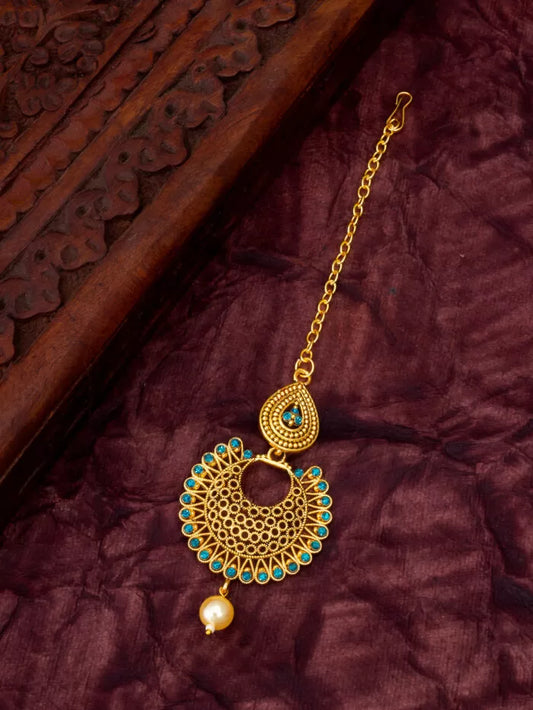 Beautiful maang tikka with a blue hue reminiscent of the ocean's glow.