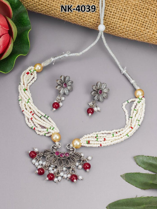 Necklace set with an oxidized finish and maroon and white bead accents.