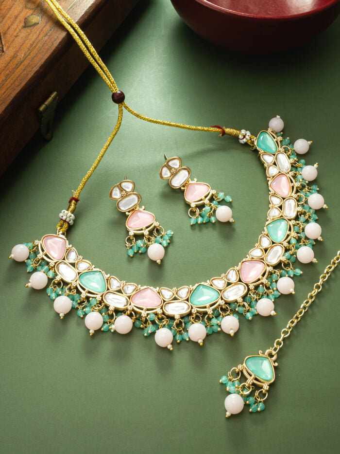 Elegant multicolor kundan necklace set with pastel hues, including earrings and a maang tikka.