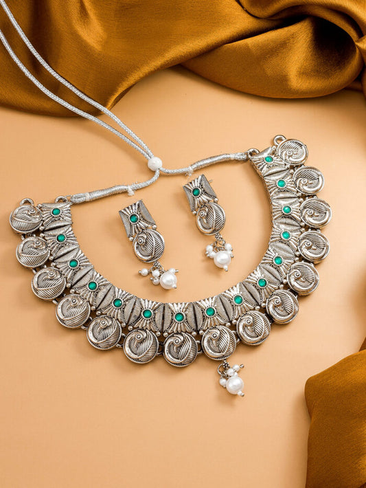 Unique oxidized silver necklace set with a spiral design and peacock motifs.