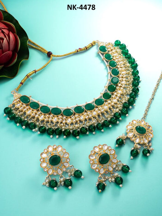 Regal jewelry set with green meenakari enamel work and kundan accents.