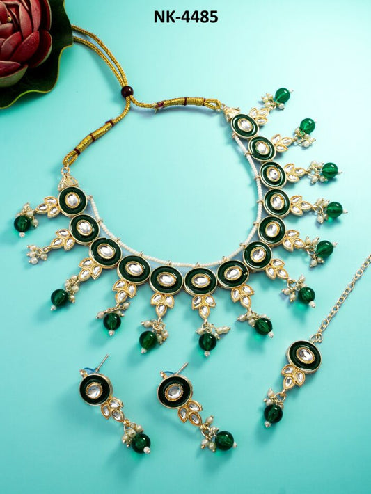 Regal jewelry set with emerald-colored meenakari enamel work.