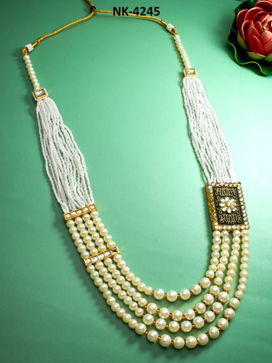 Elegant statement necklace featuring multiple layers of white pearls with a royal design.