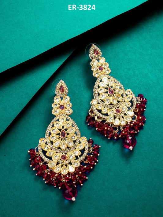 Regal chandelier earrings with maroon and pink kundan work.