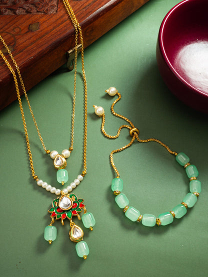 Regal necklace and bracelet set with meenakari enamel work and mint-colored kundan stones.