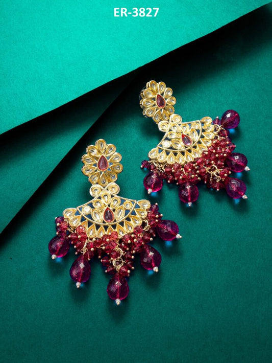 Regal chandelier earrings with pink and maroon kundan work.