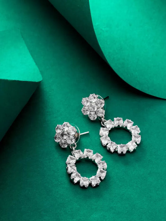 Classic silver drop earrings with a circular design and 'AD' (American Diamond) stones.