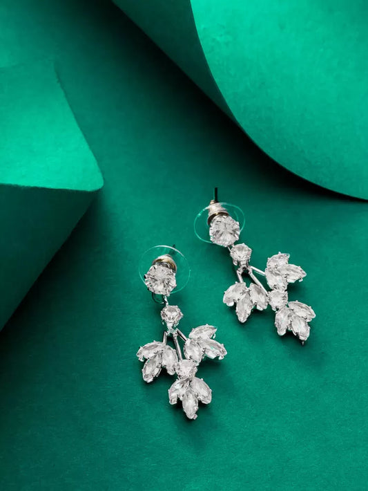 Delicate silver drop earrings with a leafy design and 'AD' (American Diamond) stones.