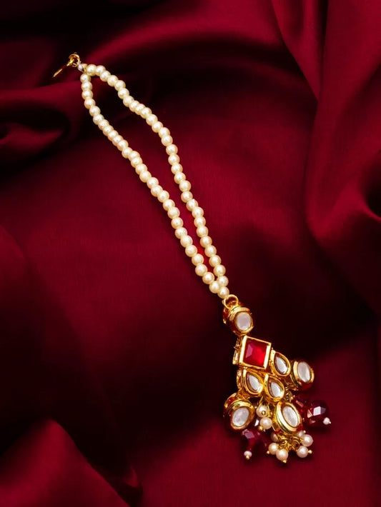 Lively maang tikka with colorful kundan work, evoking a 'vibrant dream'.