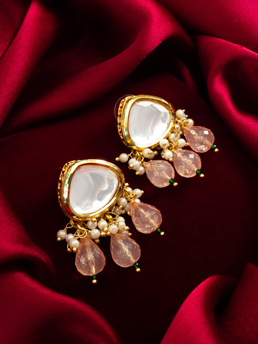Delicate drop earrings with white kundan work and soft blush pink bead accents.