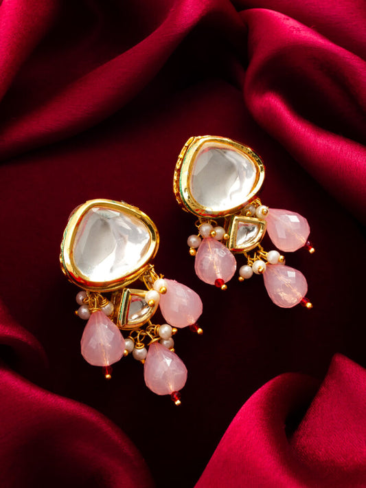 Elegant drop earrings featuring white kundan work and rose pink accents.